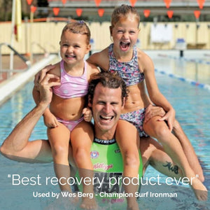 Wes Berg, a NutriGrain Ironman for more than 25 years, here holding his two daughters on his shoulders while standing in a pool. Caption says "best recovery product ever".