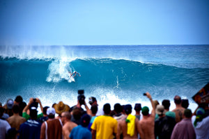 Joel Parkinson, World Surf League Champion riding a wave at on the tour with large crowd